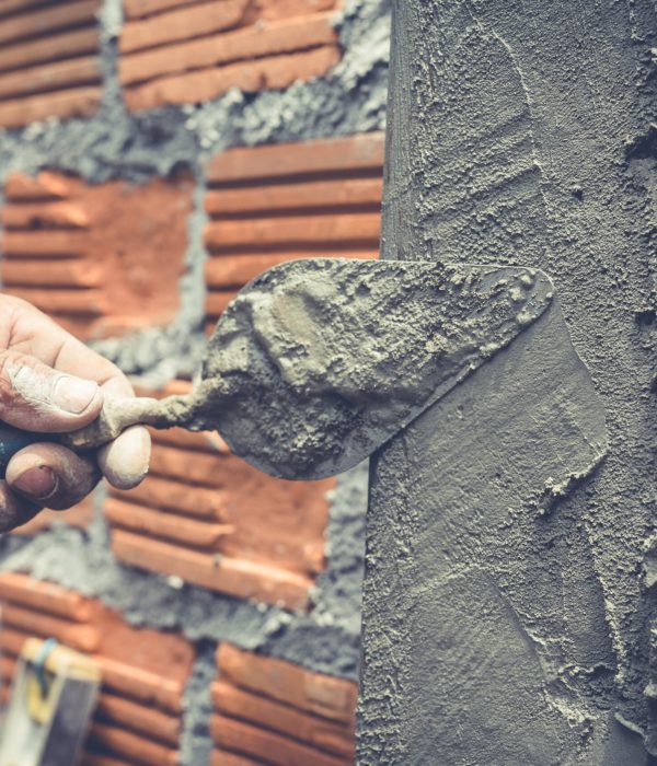 Bricklaying. Construction worker building a brick wall.